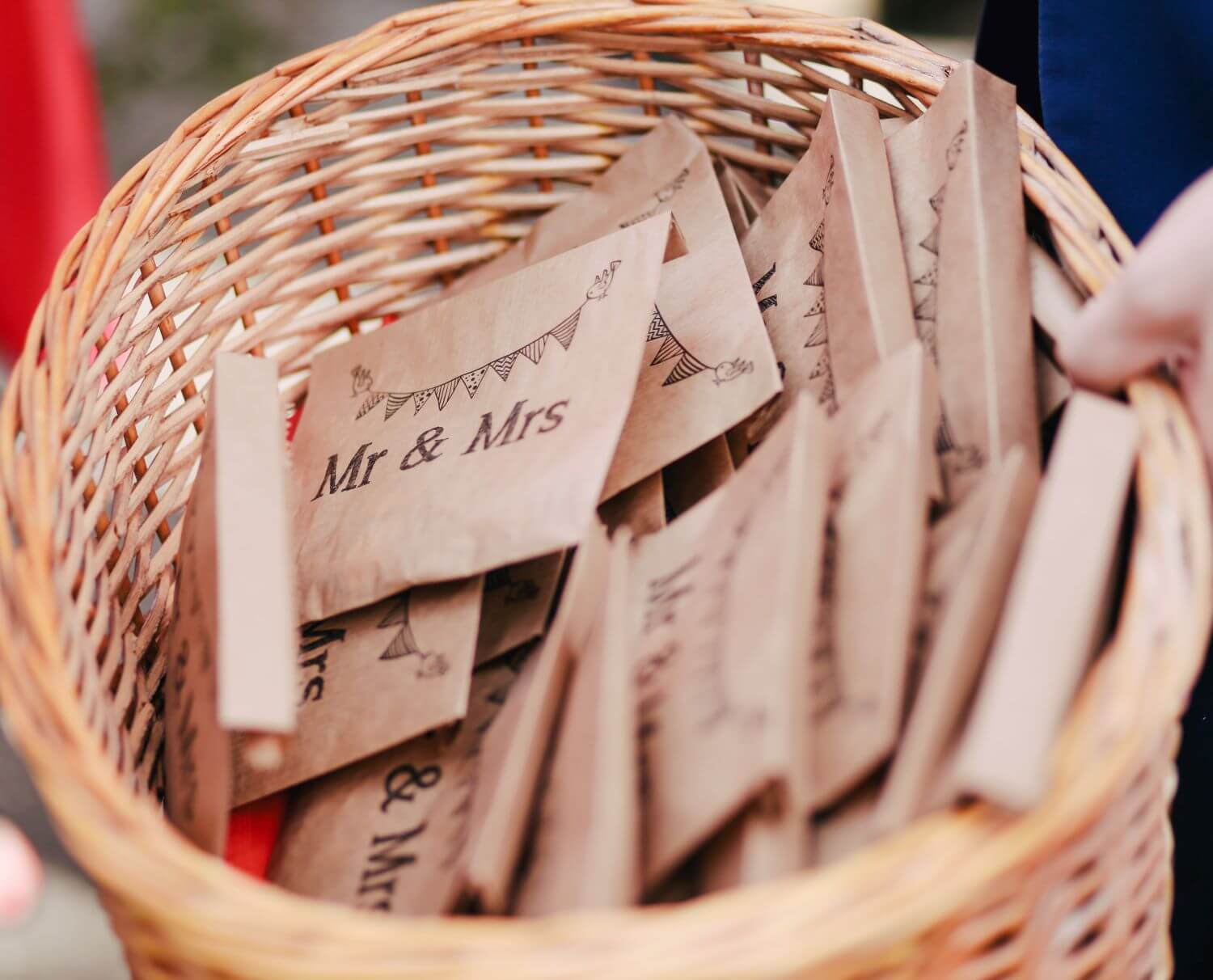 Little craft paper envelopes reading "Mr and Mrs" in a basket